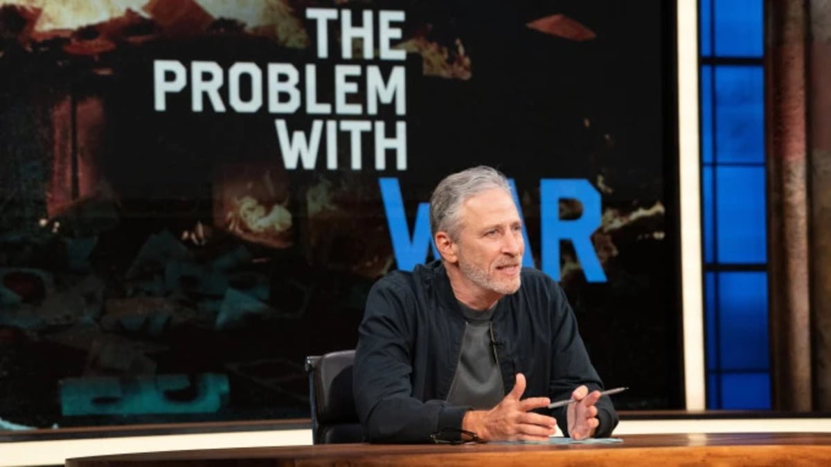 A photo of Jon Stewart at a newsdesk