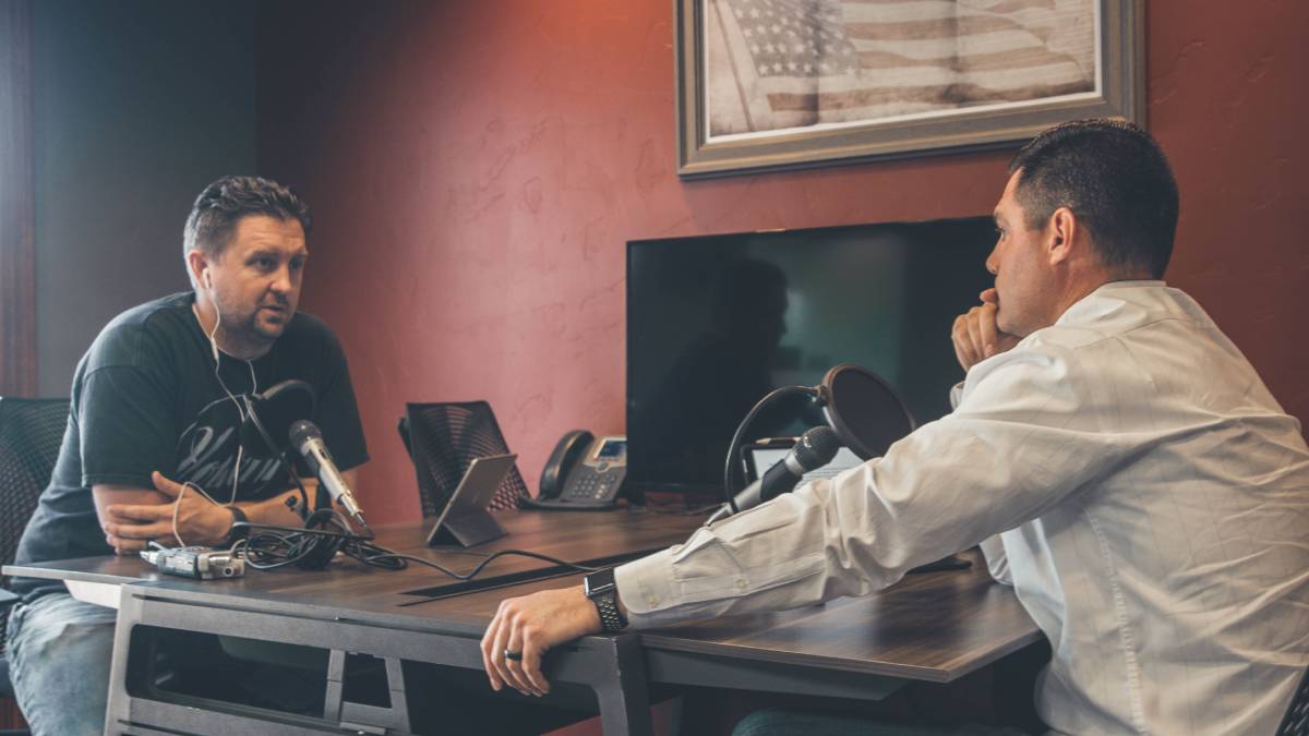 A photo of two men in a radio interview