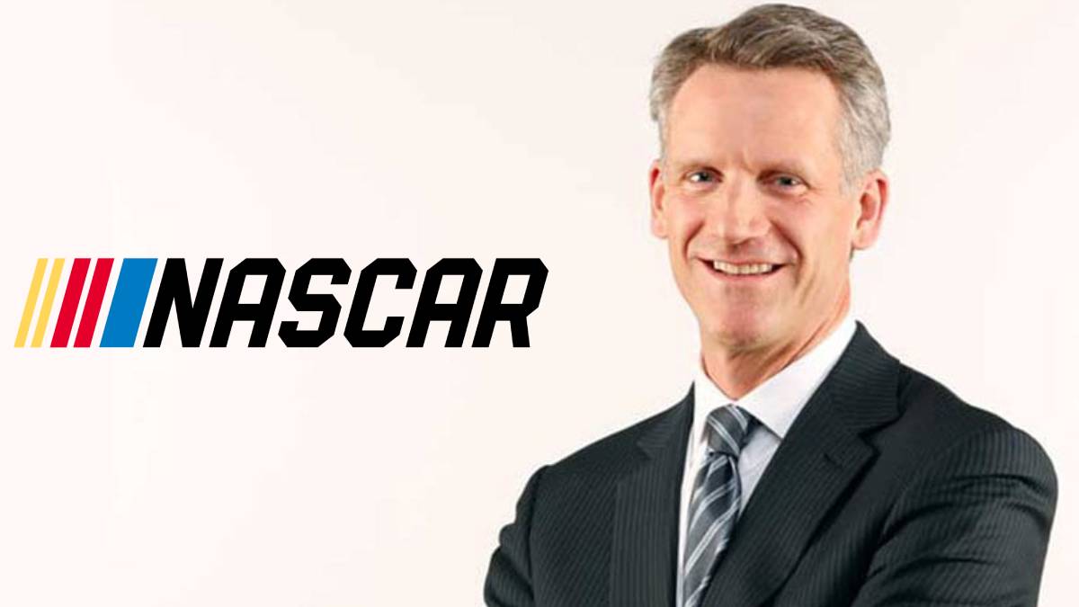 A photo of Steve Phelps and the NASCAR logo