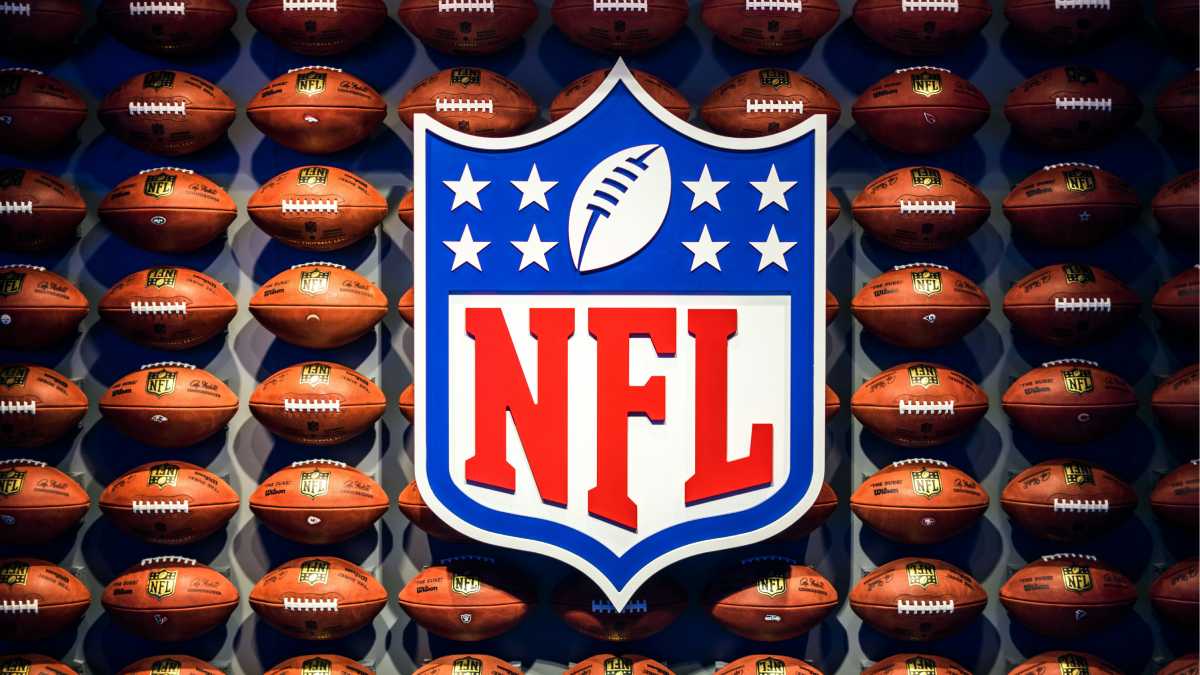 A photo of the NFL logo surrounded by footballs