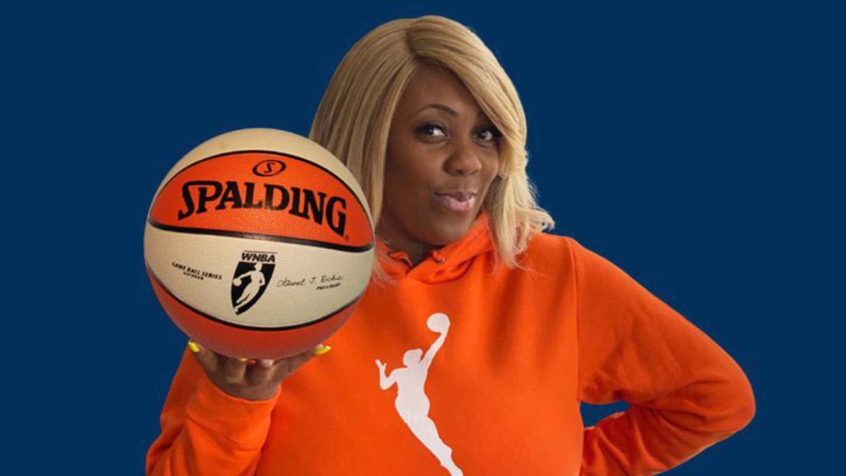 An image of Terrika Foster-Brasby holding a WNBA basketball