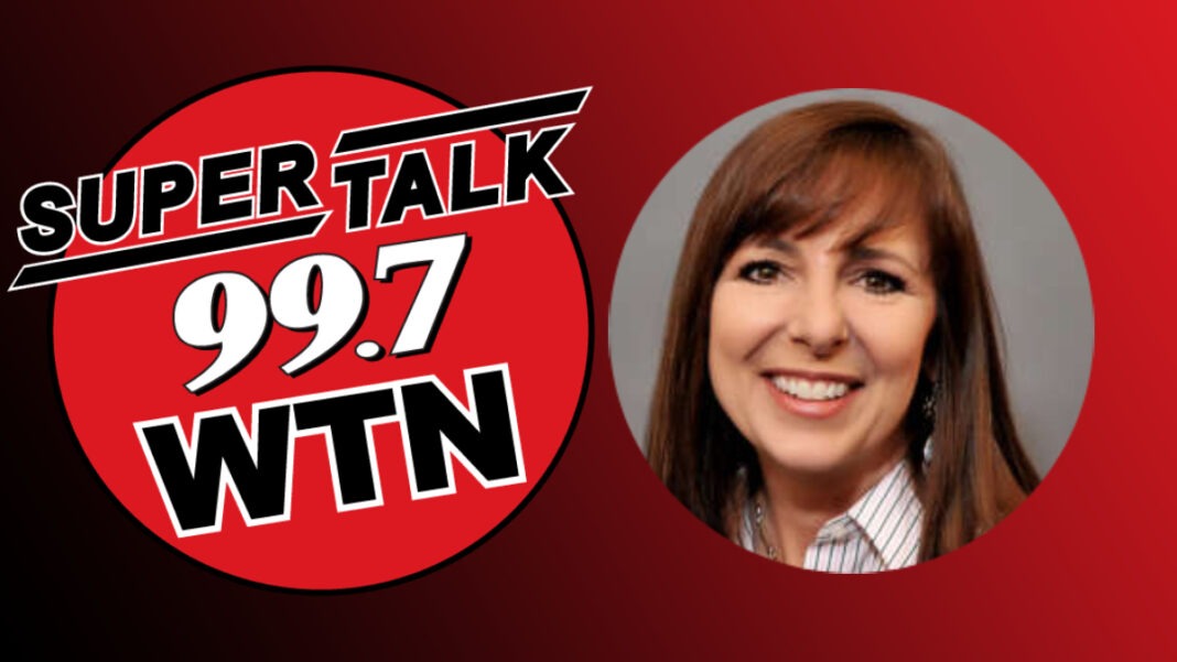 A photo of Joan Jones and the SuperTalk 99.7 WTN logo